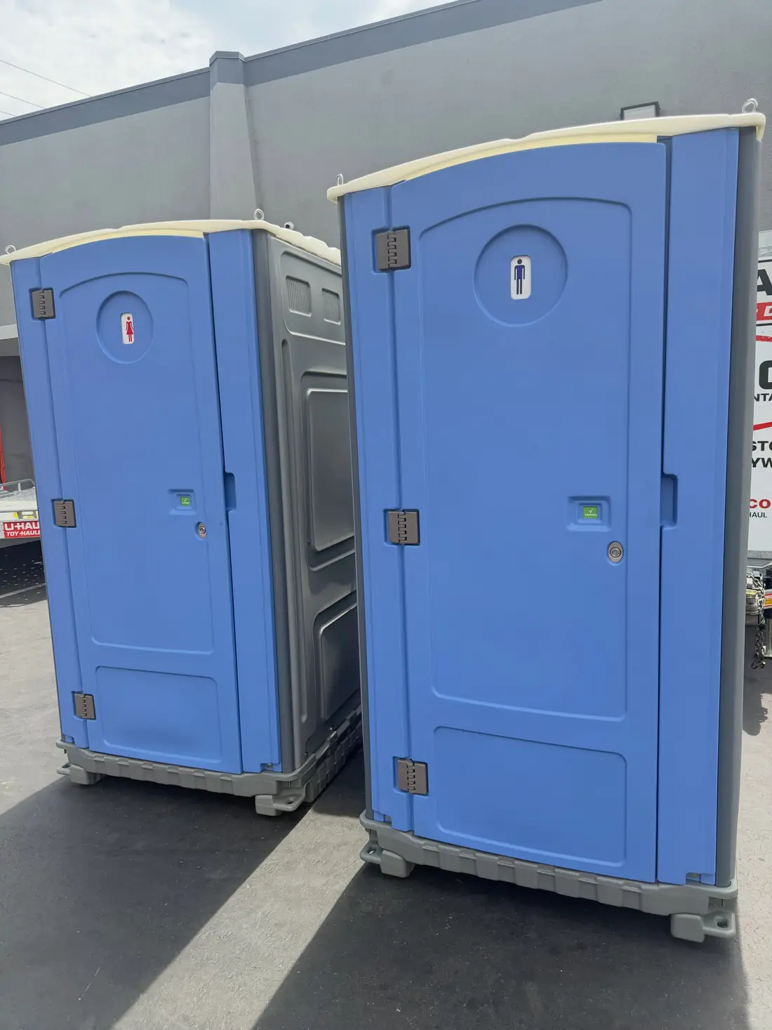 Two blue porta potties side by side